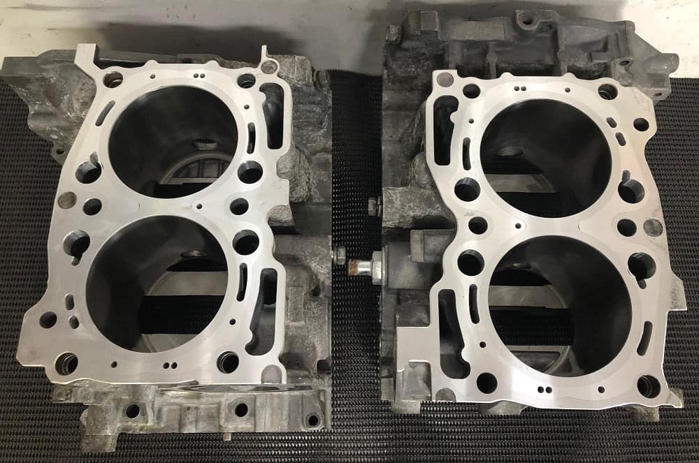 Two EJ engine case halves after CNC close decking at SPR Performance, coolant passages cut to the head gasket type