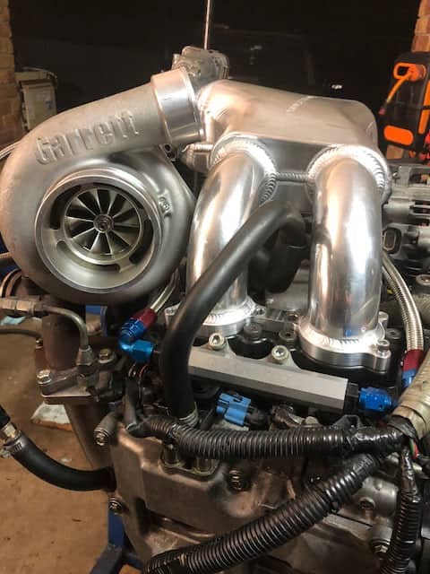 Garrett turbocharger mounted on a tubular top mount manifold on a Subaru EJ engine at SPR Performance